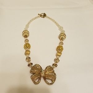 Gold and white beaded bow necklace